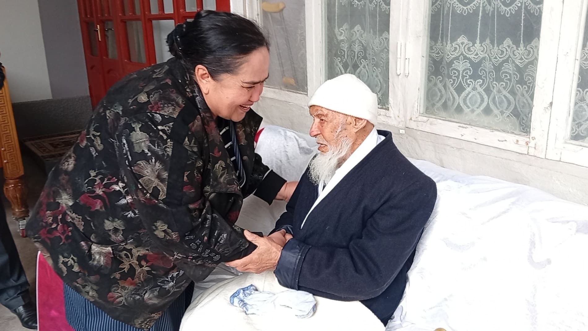 A warm meeting in the home of a centenarian elder